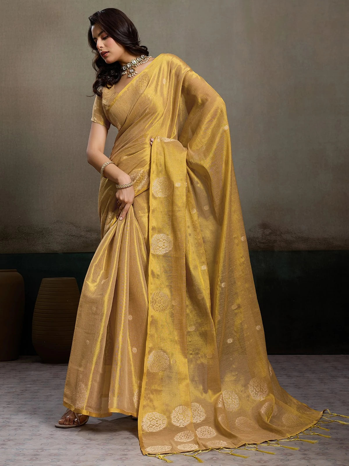 Tarani Samaira golden tissue silk saree full view with woven motifs and tassel pallu for festive and wedding wear