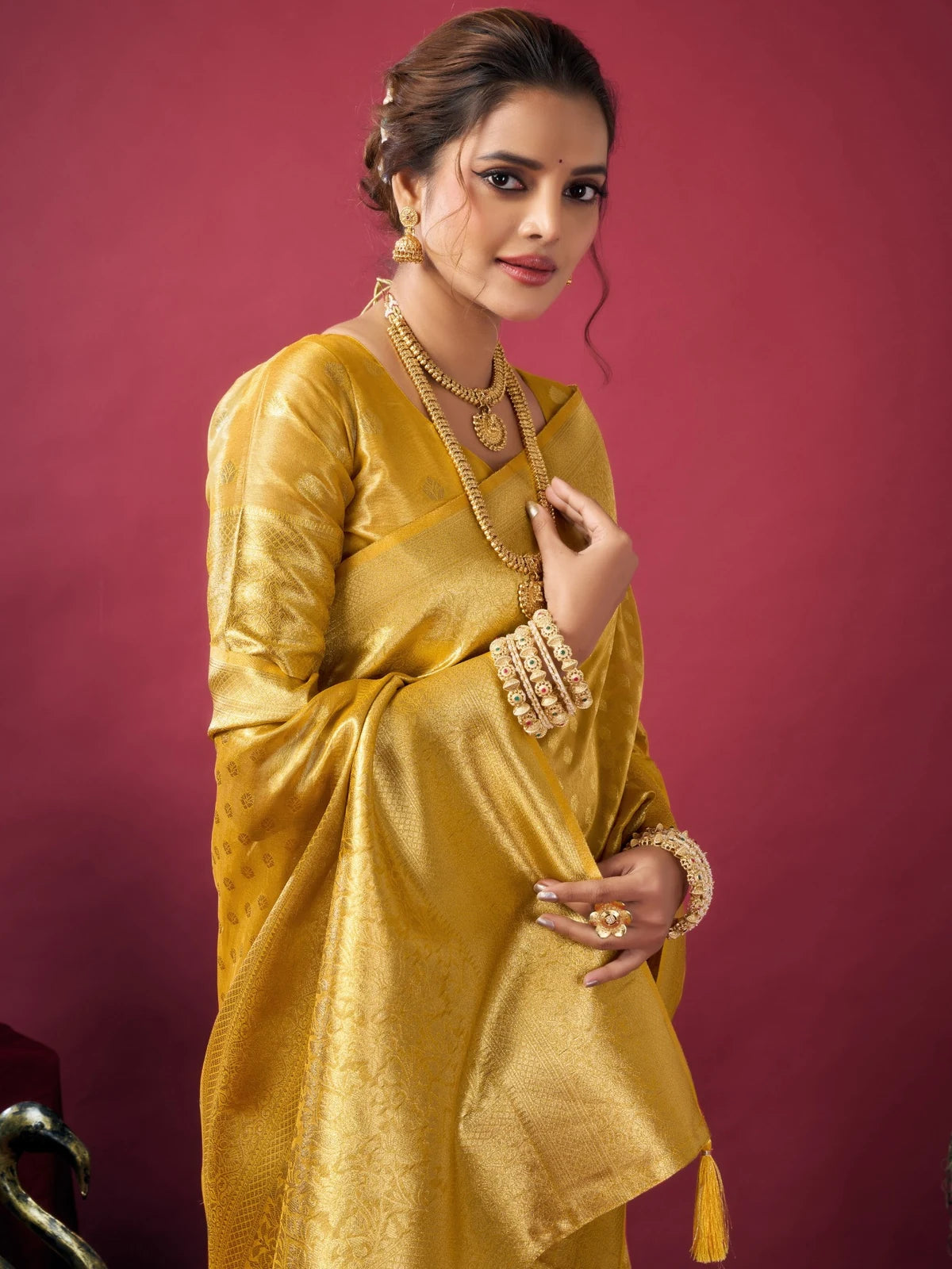 Tarani Rashmika golden Tissue Silk saree pallu view showcasing zari woven border and tassels