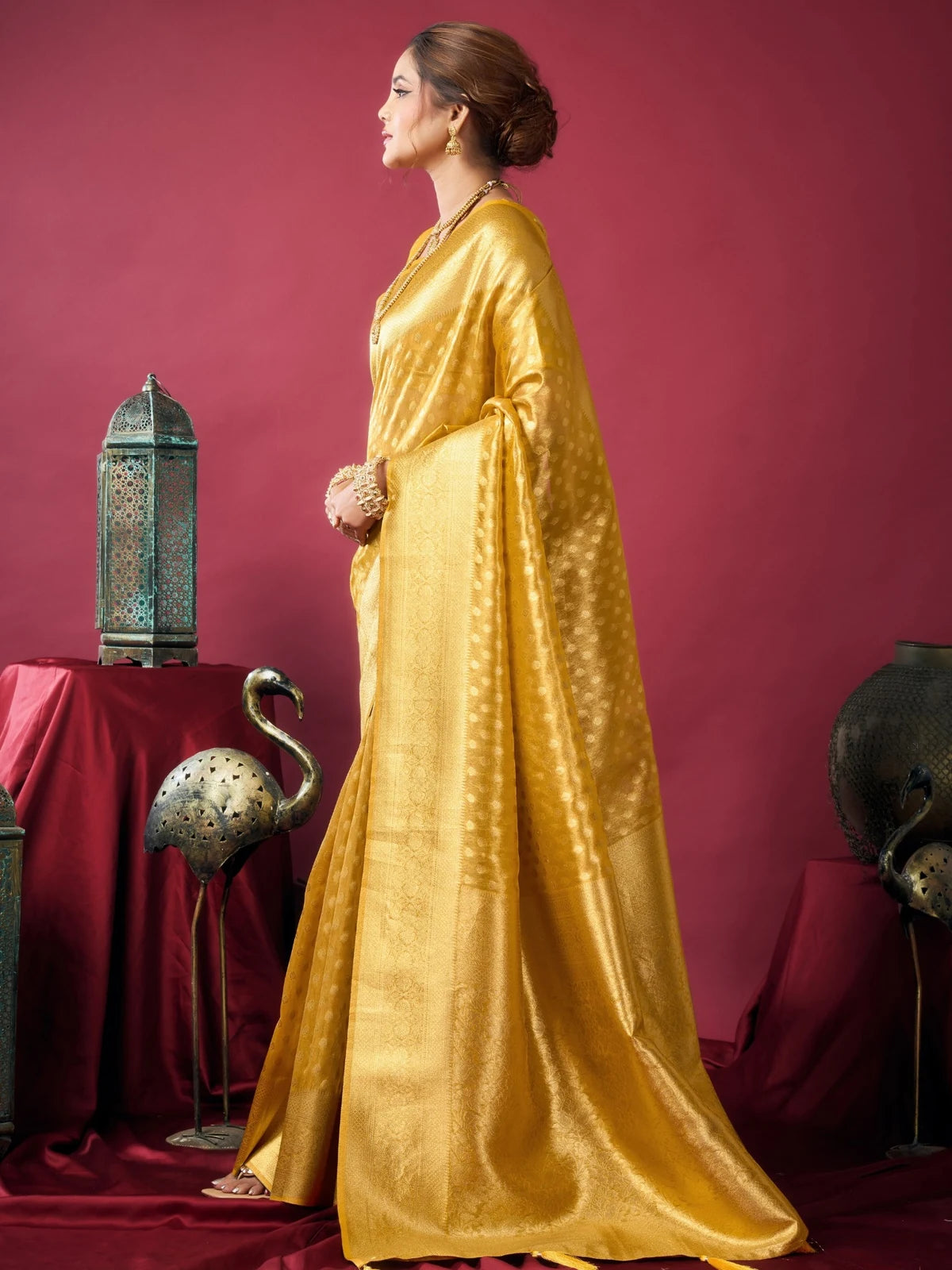 Tarani Rashmika golden Tissue Silk saree side view with flowing pallu and festive styling