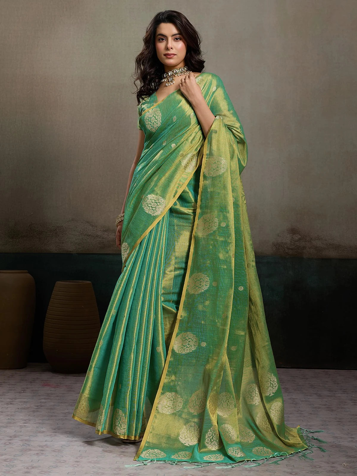 Tarani green tissue silk saree front view with elegant zari motifs and flowing drape