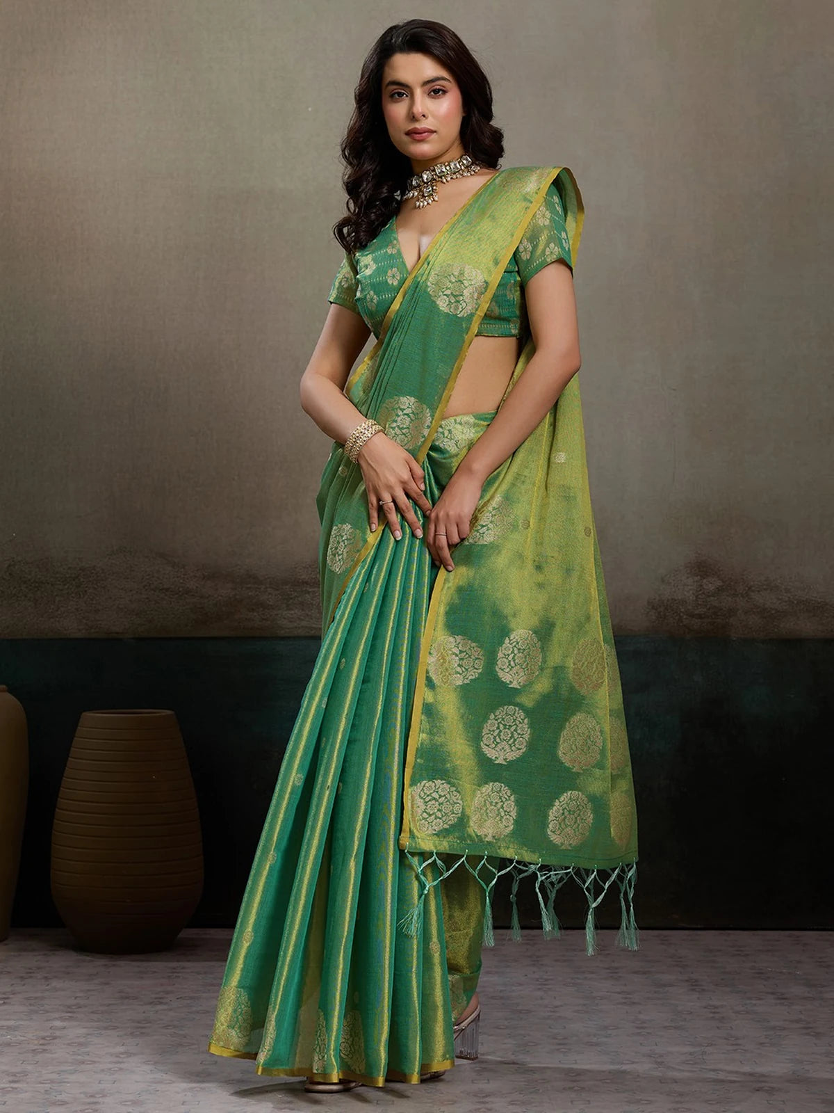 Tarani green tissue silk saree full view with zari motifs and tassel pallu for festive and wedding wear