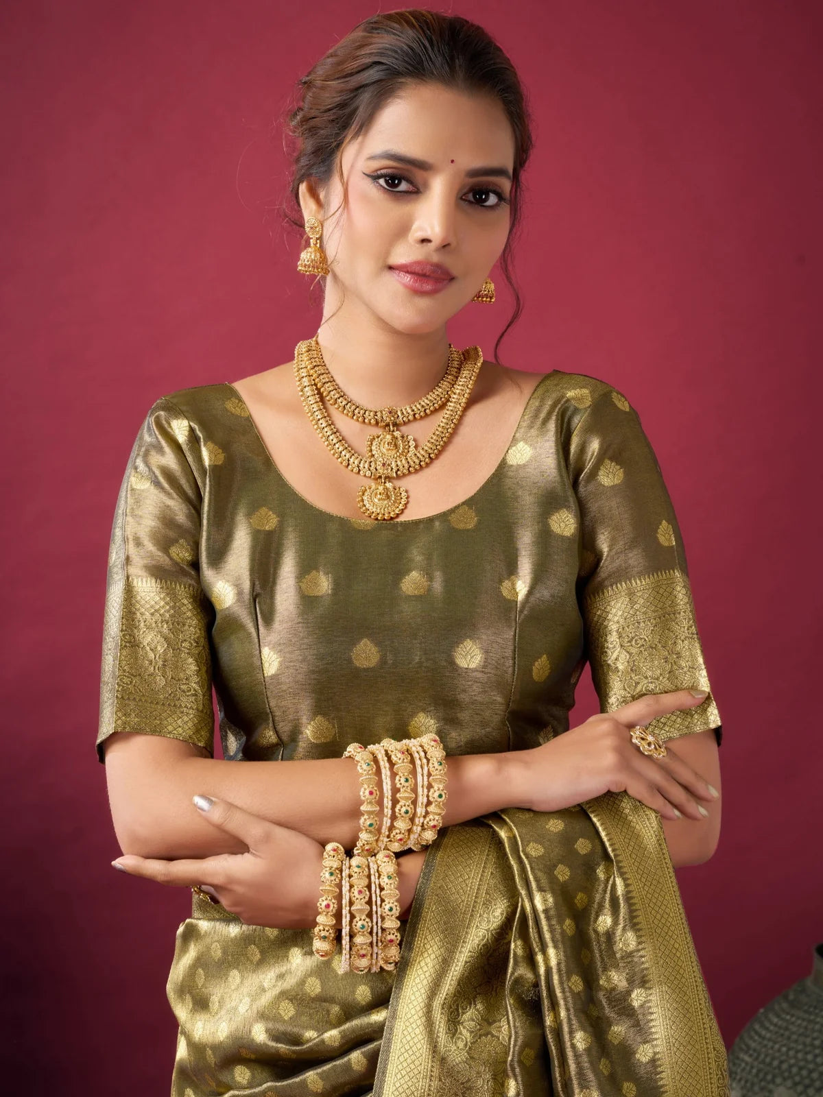 Tarani Snehal green Tissue Silk saree upper body view with blouse detailing and woven zari motifs