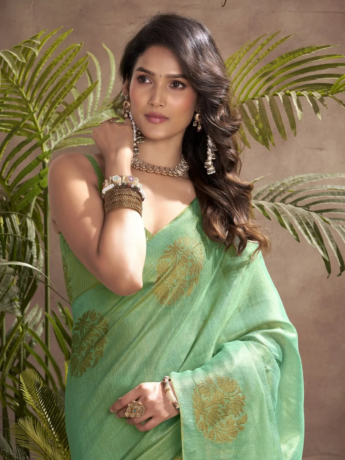 Tarani green tissue silk saree upper body view with elegant blouse and golden motifs