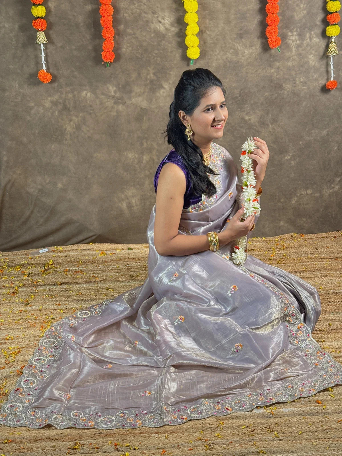 Tarani lavender tissue silk saree closeup showcasing delicate floral work and fabric shine