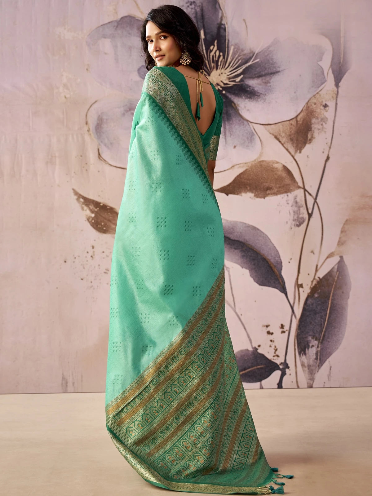 Tarani mint green tissue silk saree back view showcasing jacquard pallu and tassels