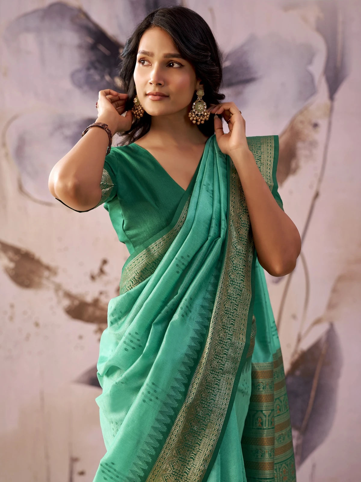 Tarani mint green tissue silk saree upper body view showing elegant zari border and blouse