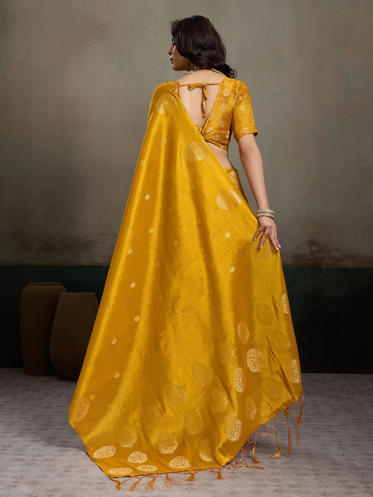 Tarani mustard tissue silk saree Shefali back view with woven motifs and blouse