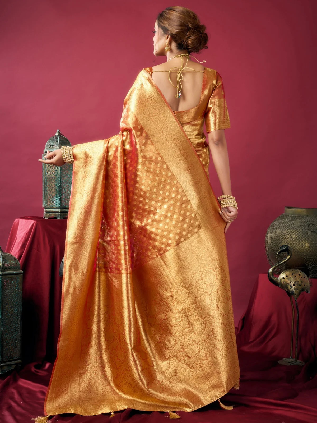 Tarani orange tissue silk saree back view with blouse design and rich zari woven pallu Ameya