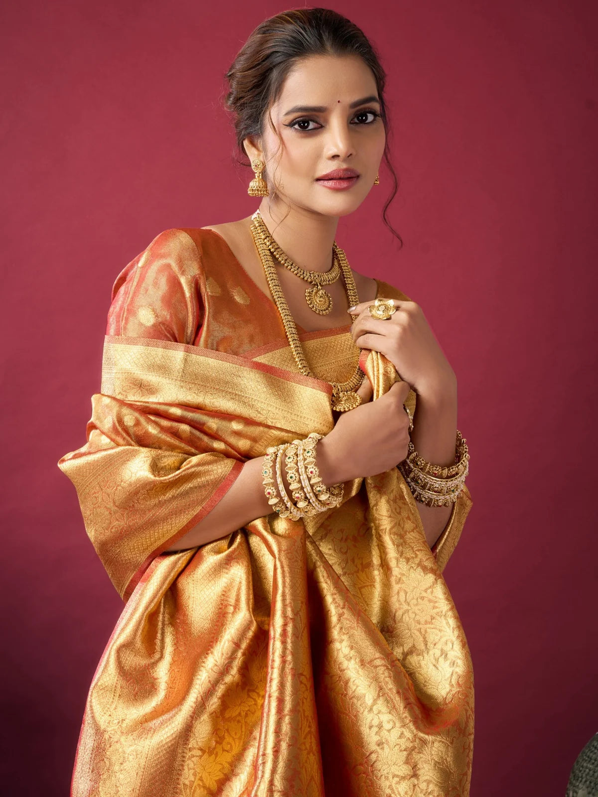 Tarani orange tissue silk saree closeup showcasing pallu border and zari woven detailing Ameya