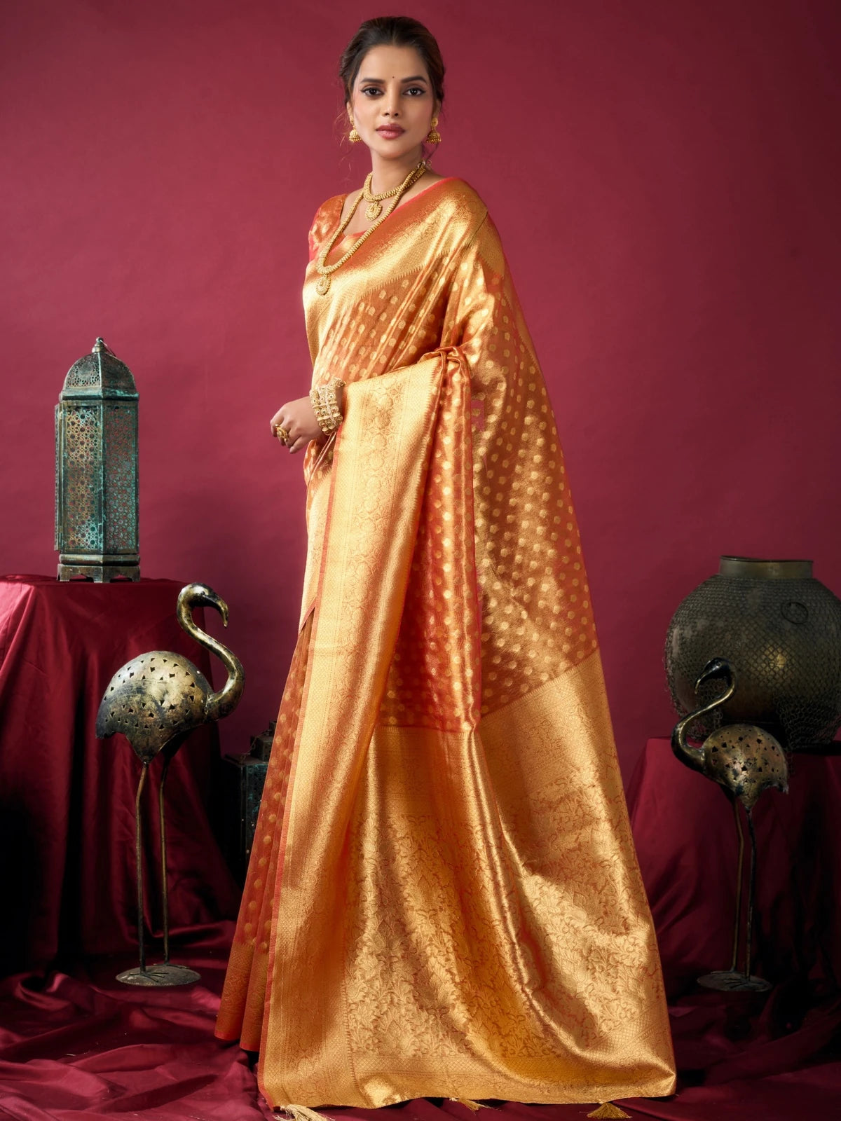 Tarani orange tissue silk saree front view with elegant drape and traditional woven design Ameya