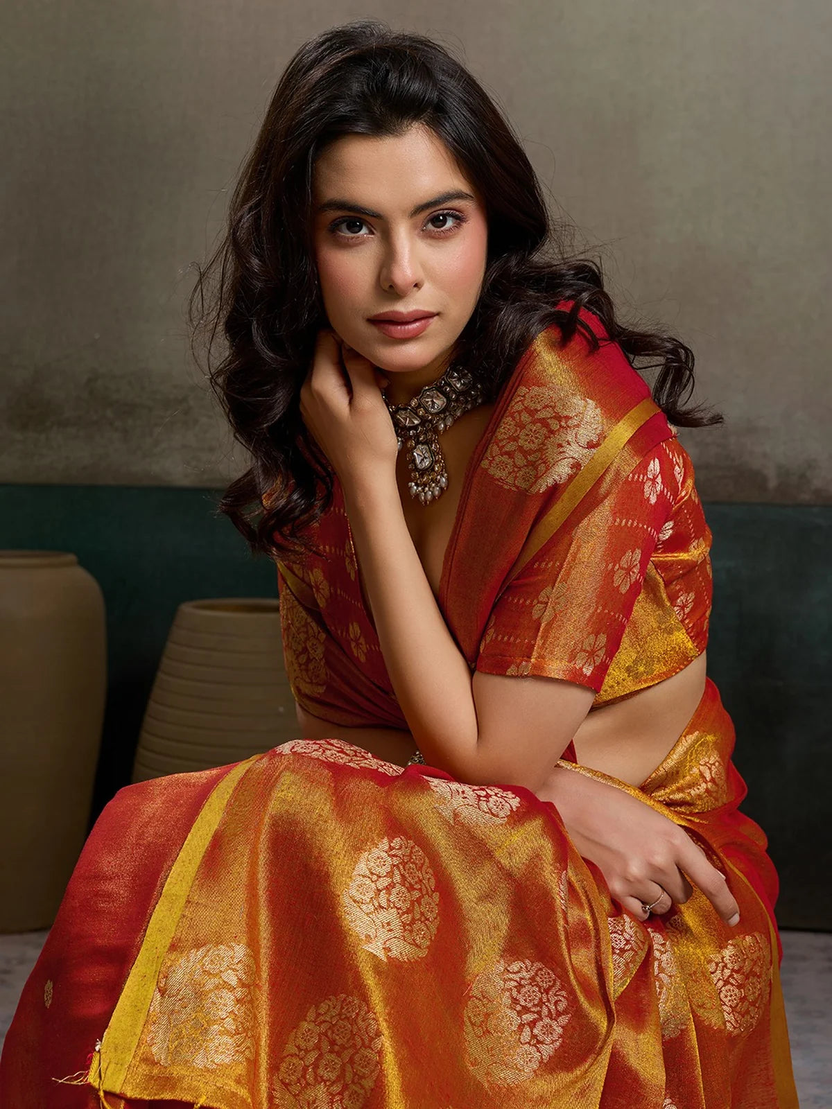 Tarani Baharika red tissue silk saree closeup with woven zari motifs and luxurious texture