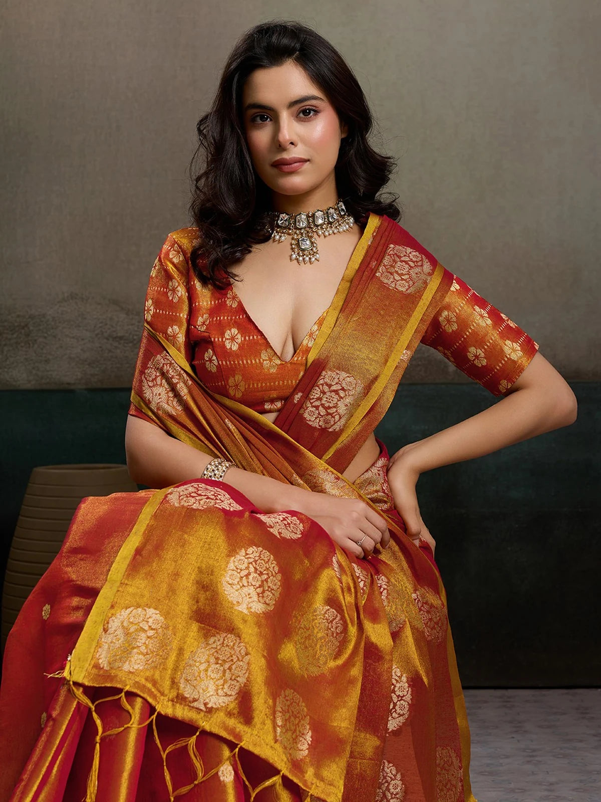 Tarani Baharika red tissue silk saree pallu view with tassels and zari border details