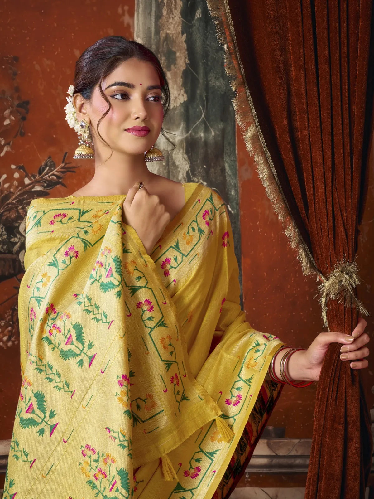 Tarani yellow premium tissue silk saree upper body view showing Paithani border and elegant drape
