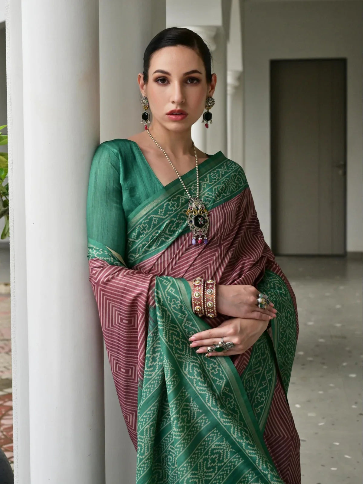 Tarani premium green tussar silk saree close-up with blouse and jewelry in upper body pose