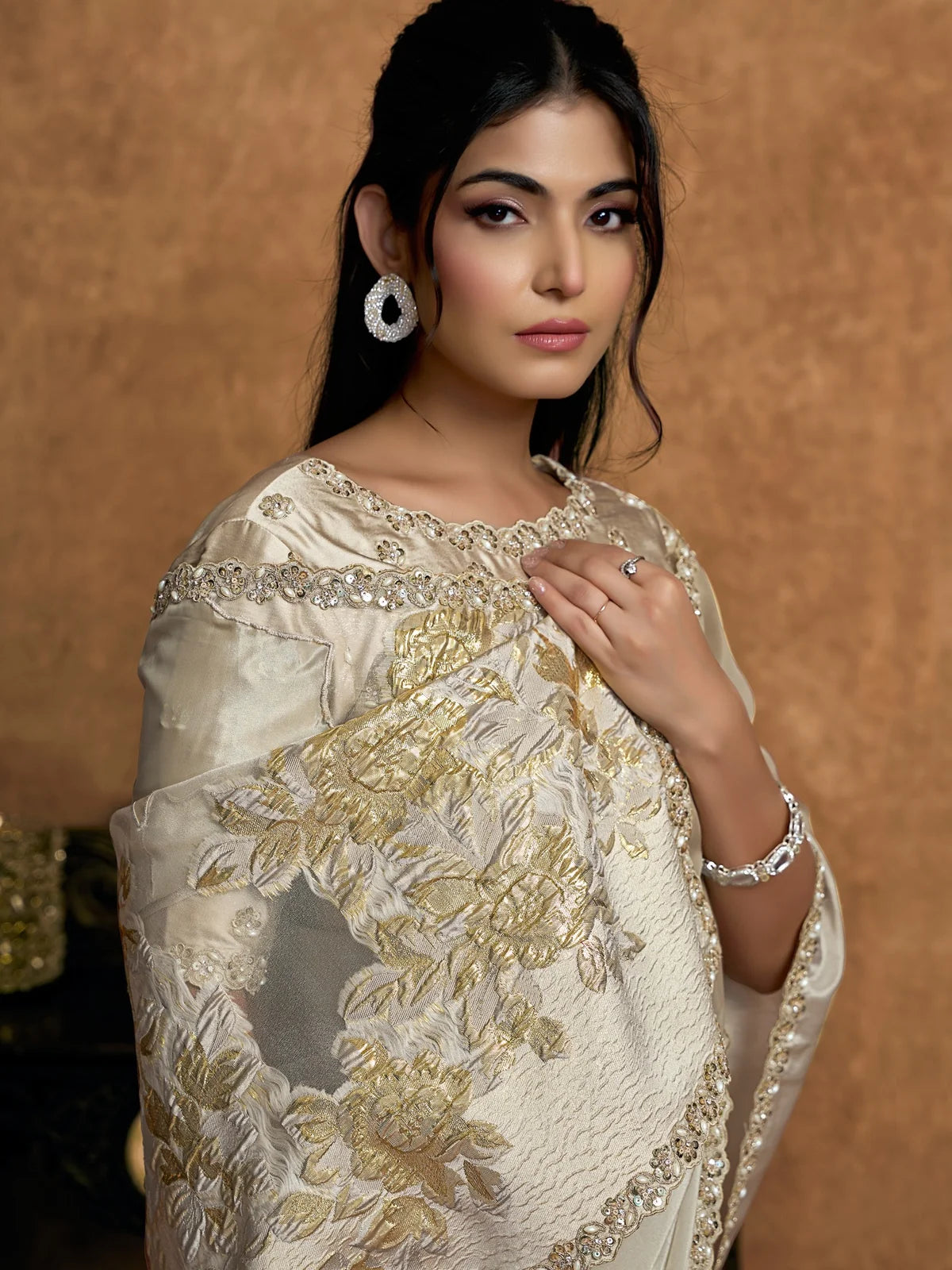 Tarani Surangi off white Uppada Silk saree closeup showcasing floral woven border and pearl detailing
