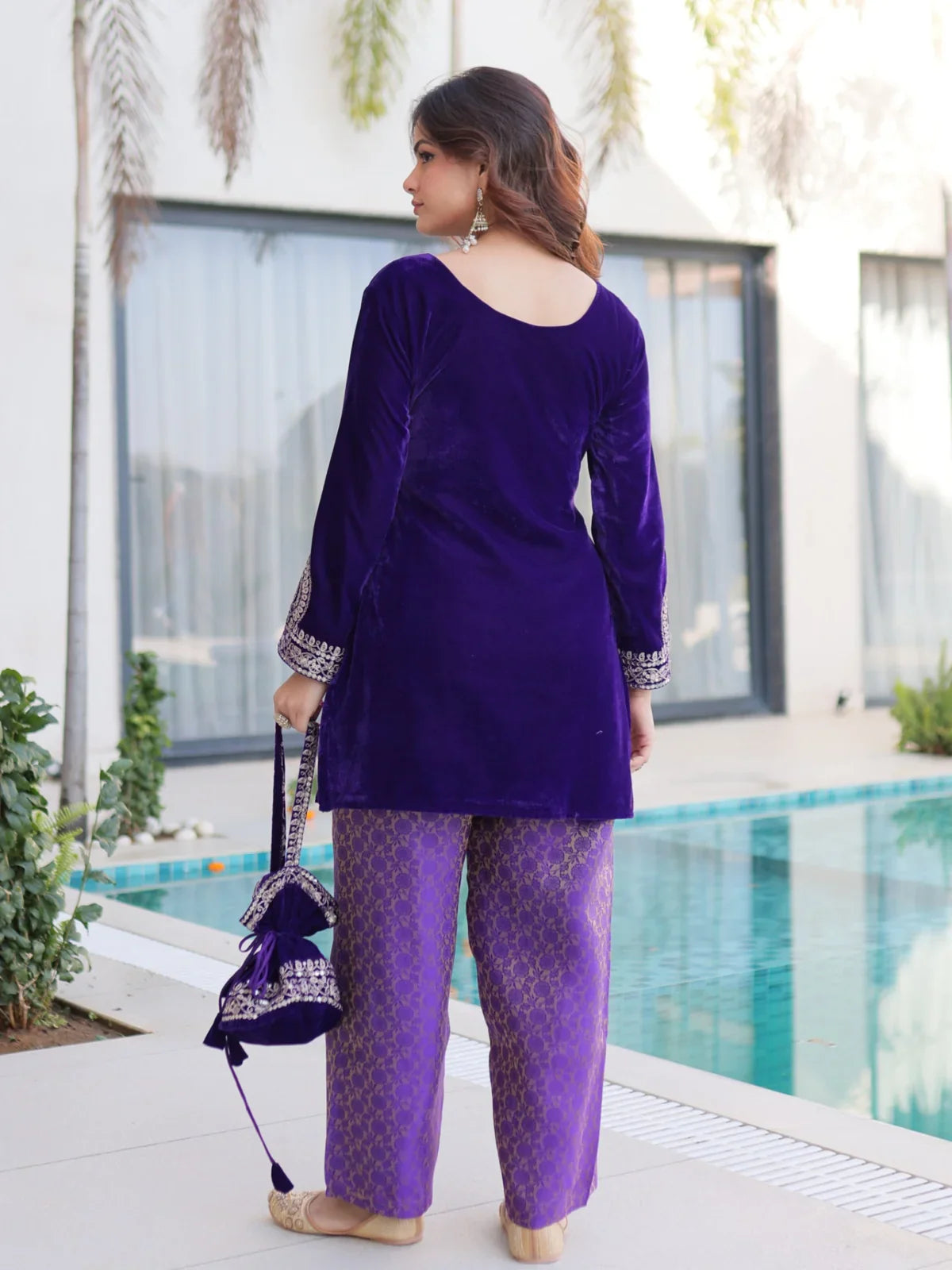 Back view of Tarani velvet festive purple dress with batwa bag