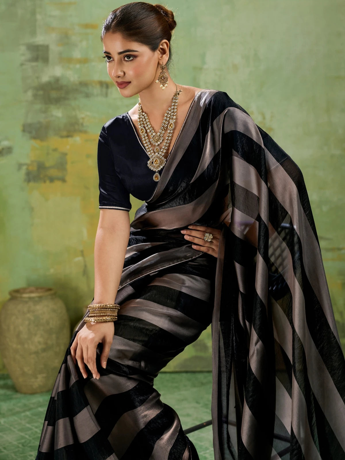 Tarani black velvet satin saree side view highlighting flowing pallu