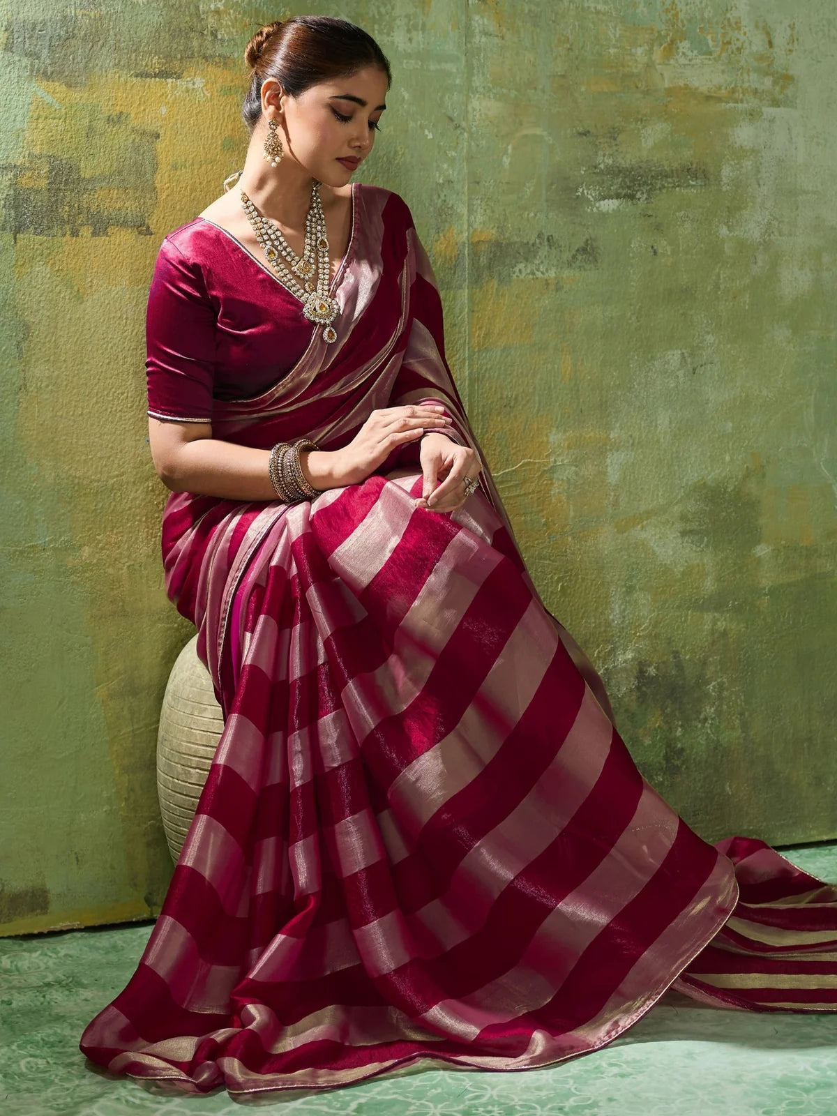 Tarani maroon velvet satin saree side pose highlighting elegant drape and border