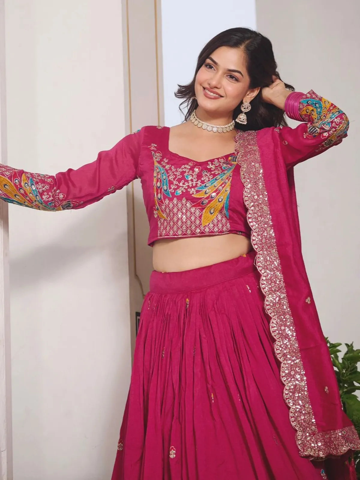 Tarani pink lehenga upper body view showcasing embroidered blouse with peacock design