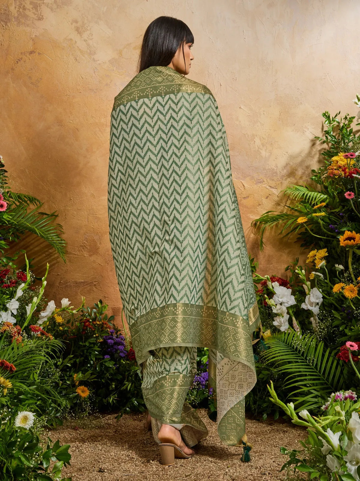 Back pose of Tarani green viscose cotton saree with full fall and border coverage in natural light