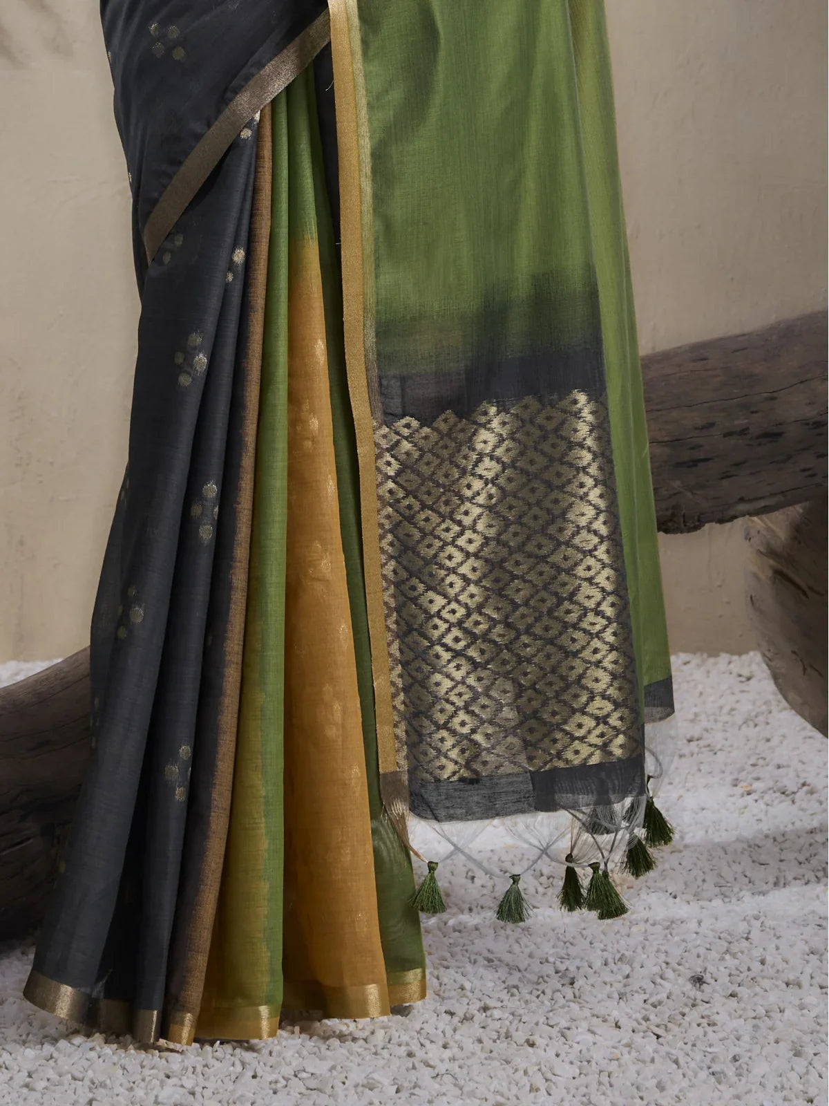 Closeup view of Tarani green viscose saree with zari border and handmade tassels