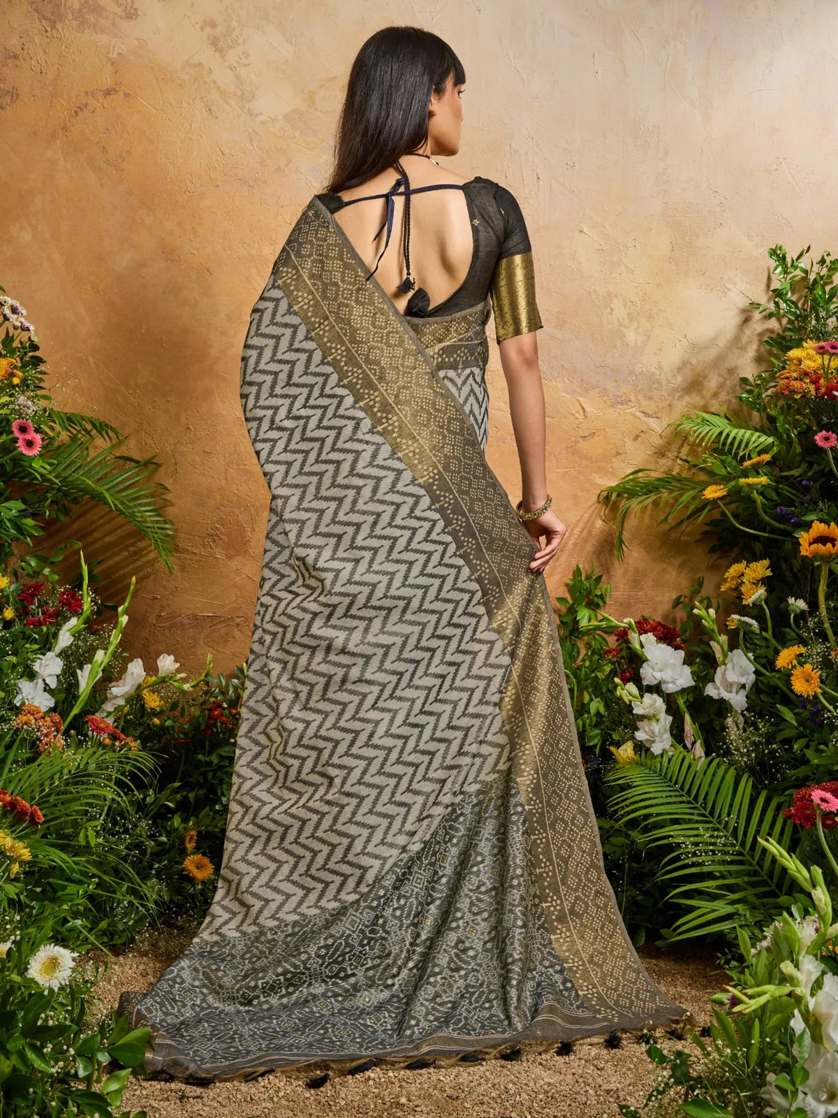 Tarani grey handloom saree back pose with elegant blouse detailing and tie-up