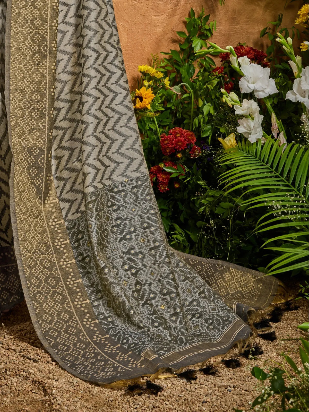 Tarani grey saree closeup showcasing patola weaving and traditional pallu design