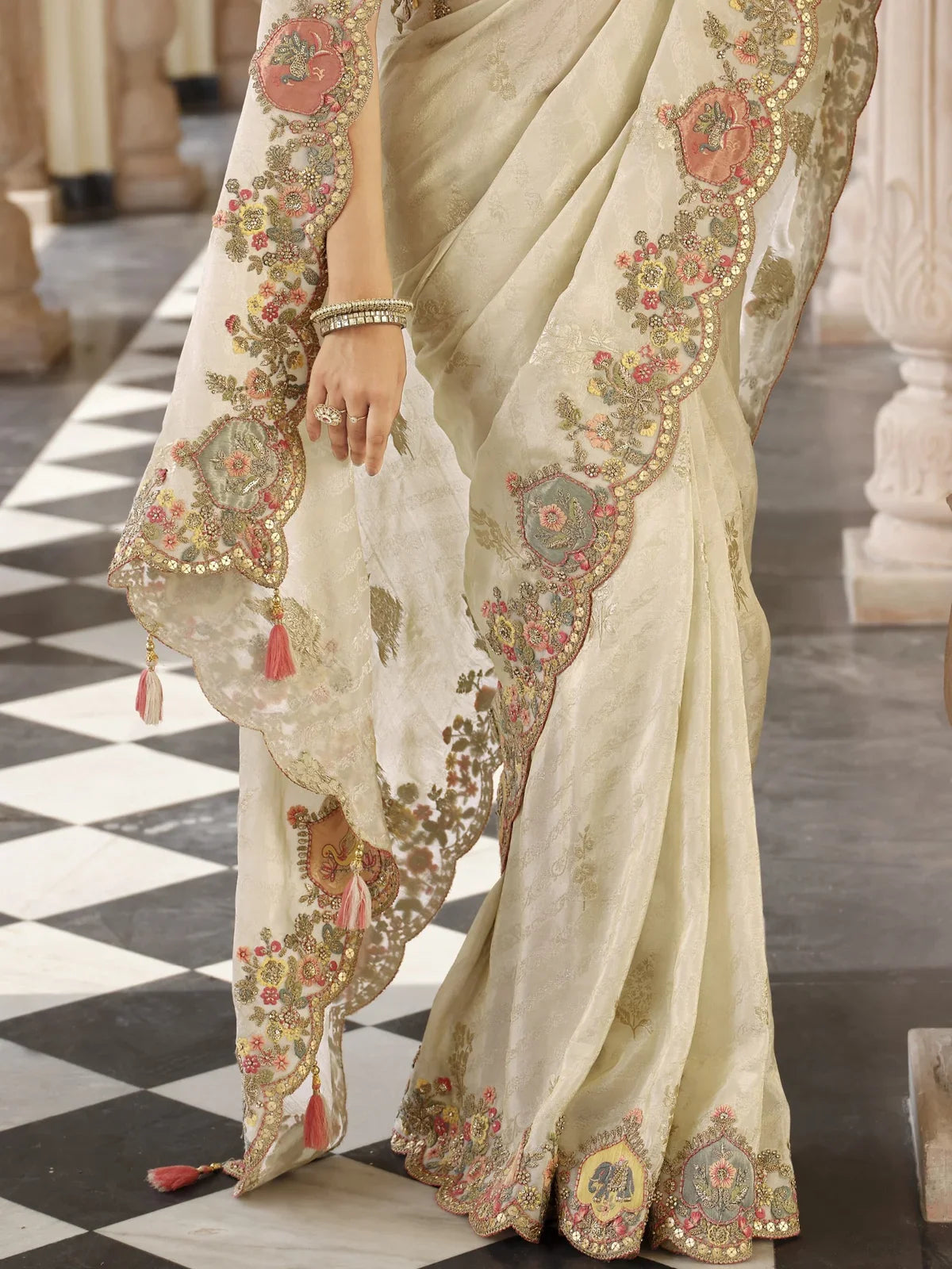Tarani beige viscose jacquard saree pallu close view with tassels and intricate border design