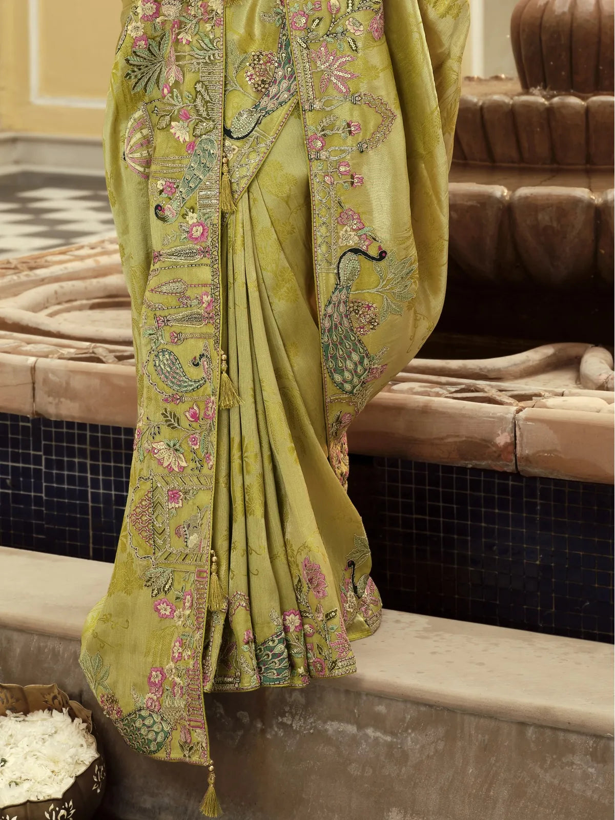 Tarani green viscose jacquard saree close pallu view highlighting tassles and peacock embroidery