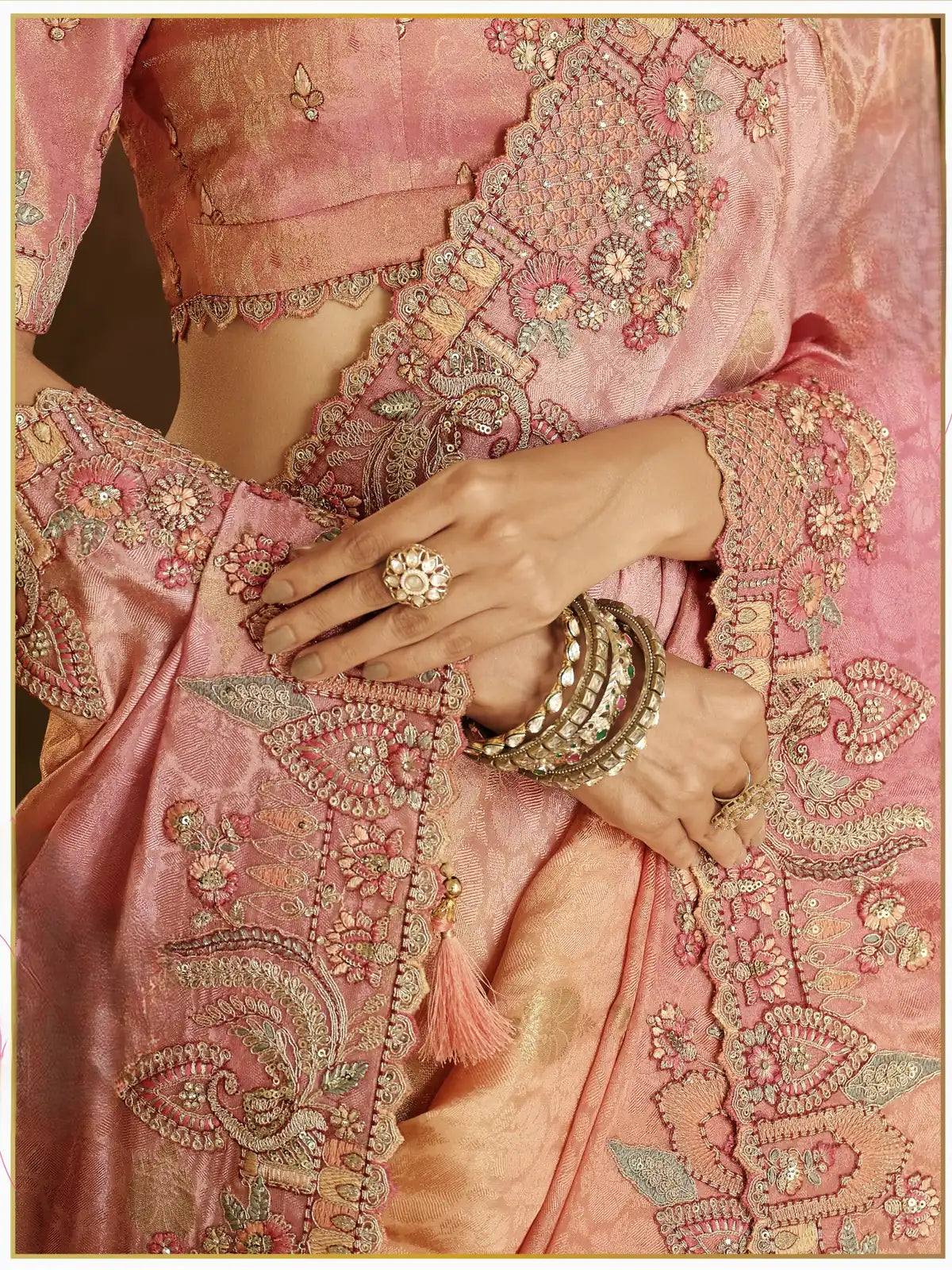 Tarani peach pink viscose jacquard saree border embroidery and tassel closeup