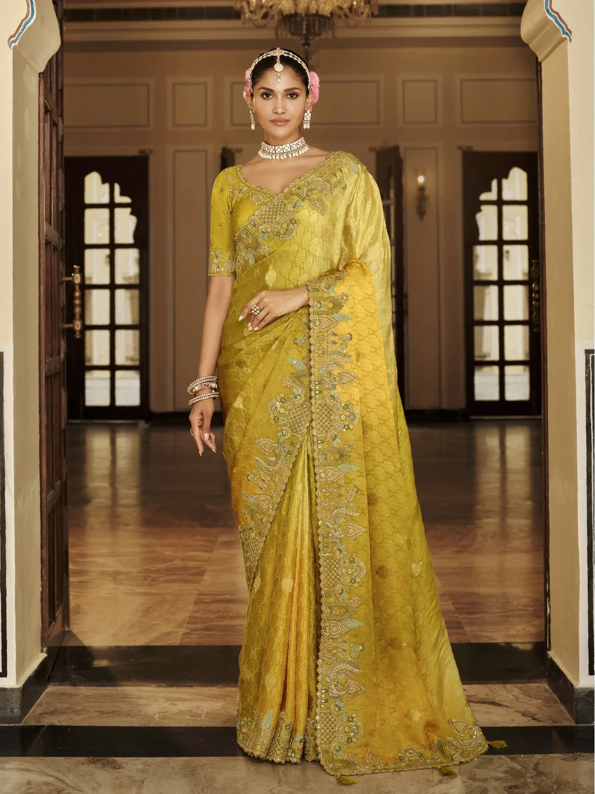 Tarani premium yellow viscose jacquard saree full view with hand embroidery and tassels paired with silk blouse