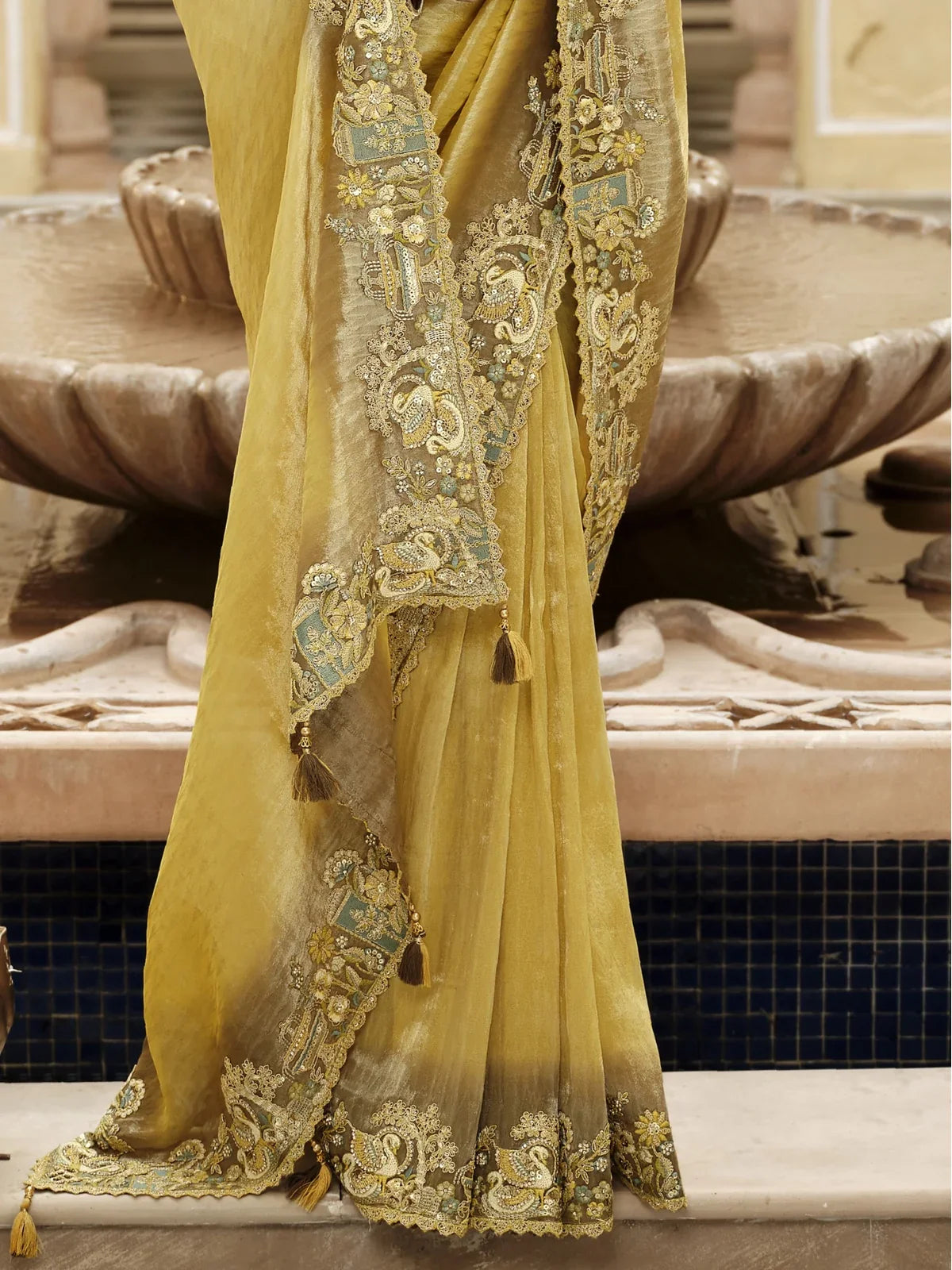 Tarani yellow viscose jacquard saree pallu view highlighting hand embroidery and tassles