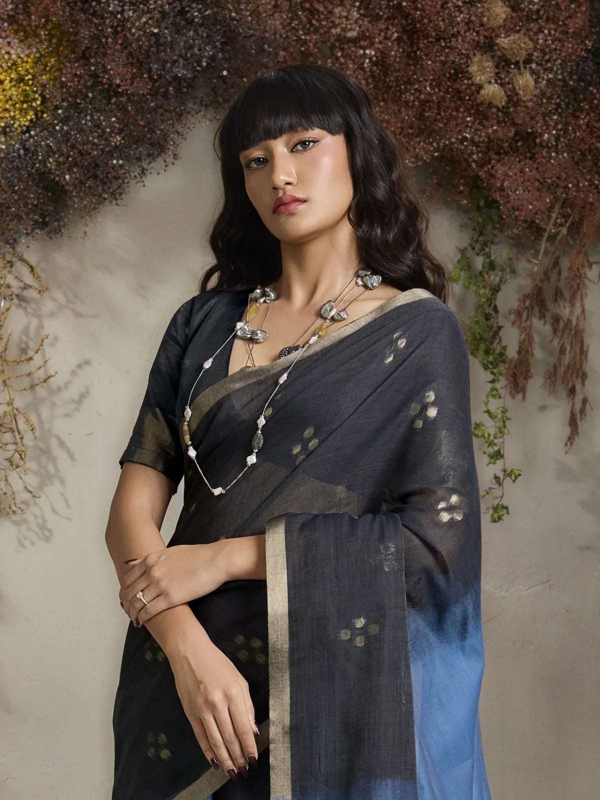 Tarani viscose green saree with close view of neckline and shoulder pleats