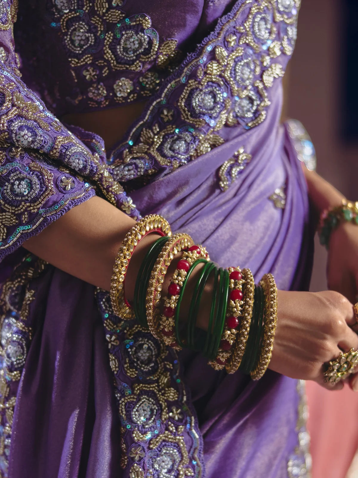 Tarani purple saree closeup showing embroidery border bead work and luxurious detailing