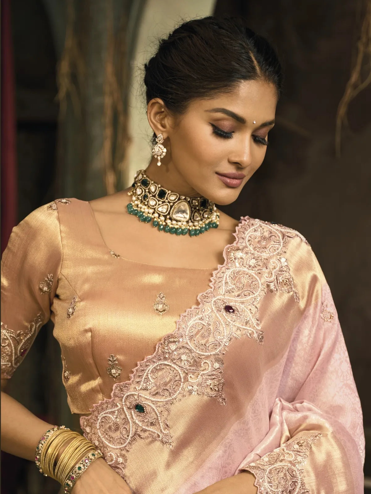 Tarani pink saree close-up showing blouse emerald detailing and soft silk texture