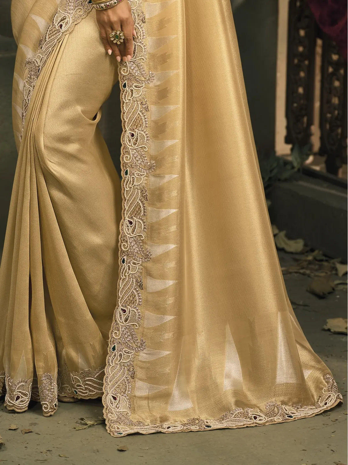 Tarani closeup view of golden Ziraf Silk saree with heavy mirror work and rich texture