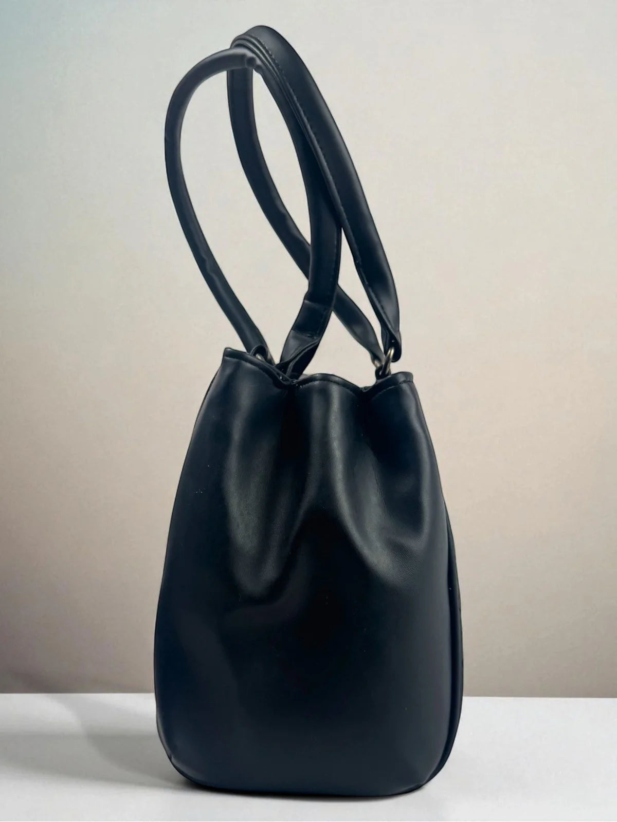 Tarani side view of navy PU leather handbag elegant and durable design